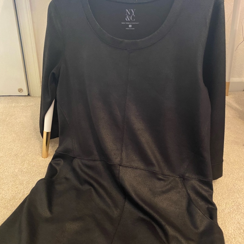 Black knee length dress with pockets.
